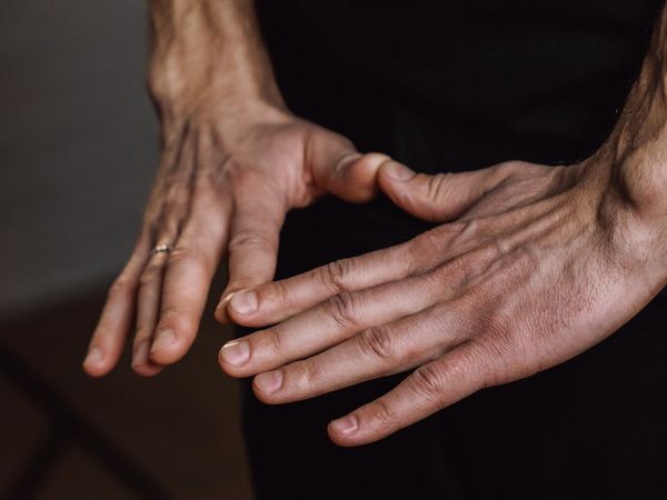 Close-up of a person's hands in a meditative mudra.